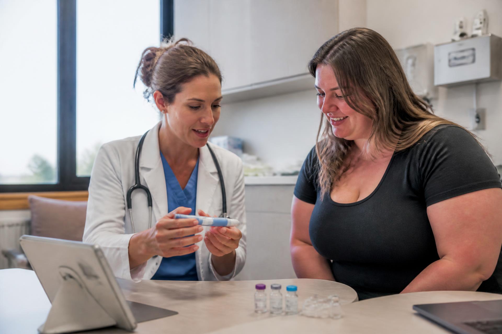 Physician reviewing a GLP-1 peptide treatment plan with a patient in a weight loss clinic